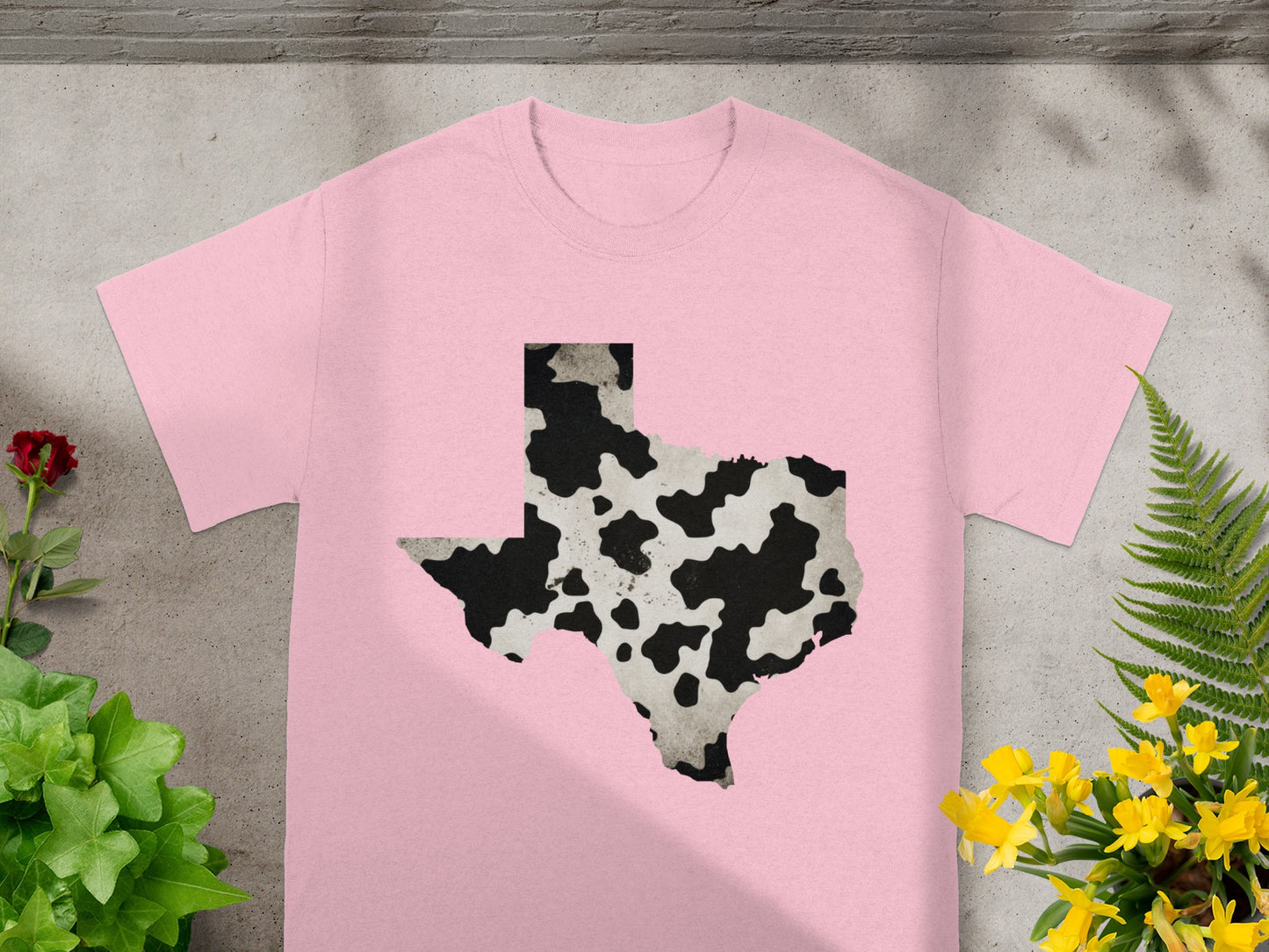 Pink t-shirt with Texas shape graphic in cow print.