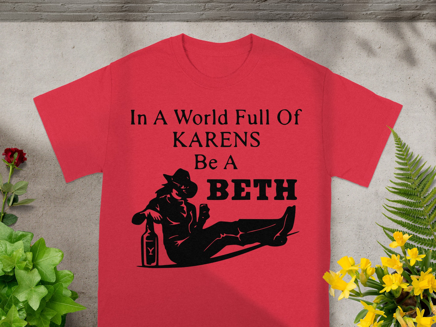Red t-shirt with "In A World Full Of Karens Be A Beth" and a silhouette.