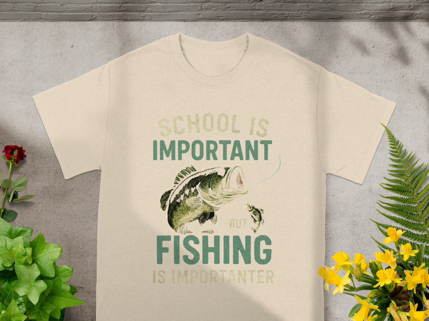 T-shirt with text "School is Important But Fishing Is Importanter" and cartoon fish.