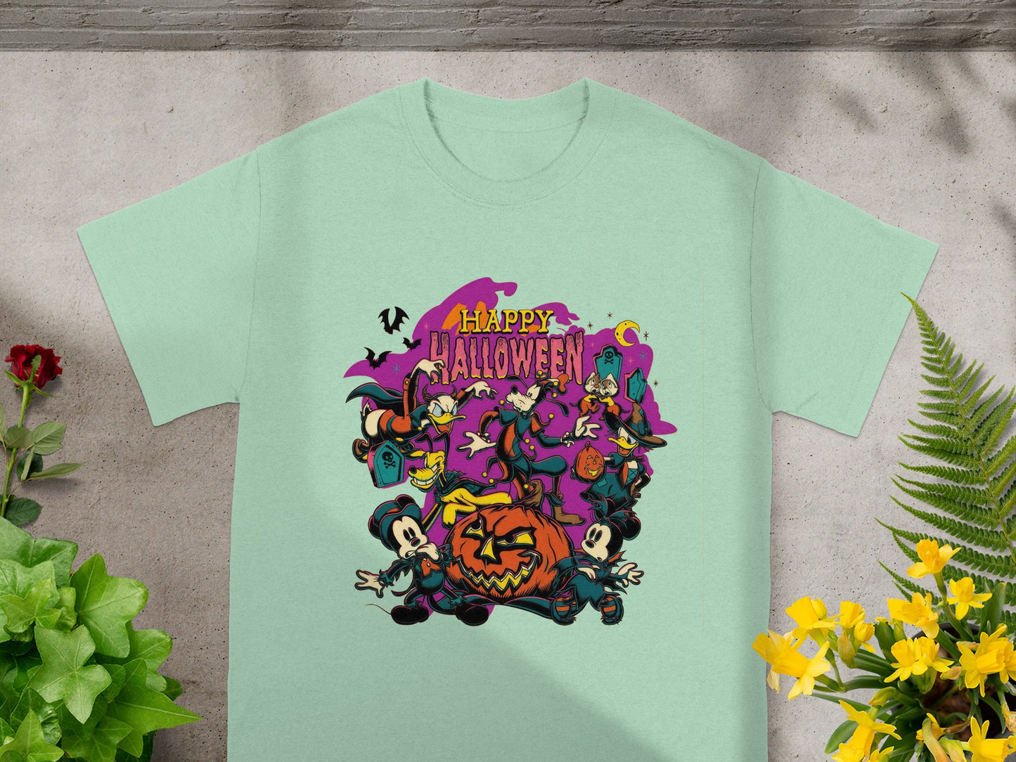 Light green t-shirt with cartoon characters and pumpkins with "Happy Halloween" text.