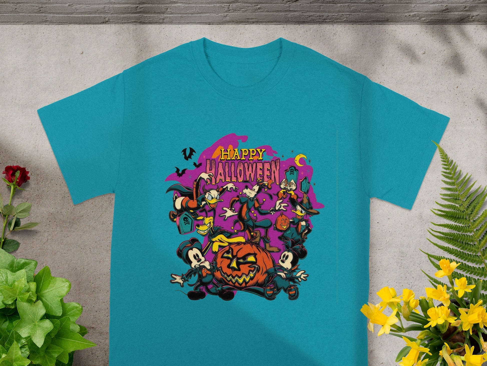 Teal t-shirt with cartoon characters and "Happy Halloween" text and Jack-o-lantern.