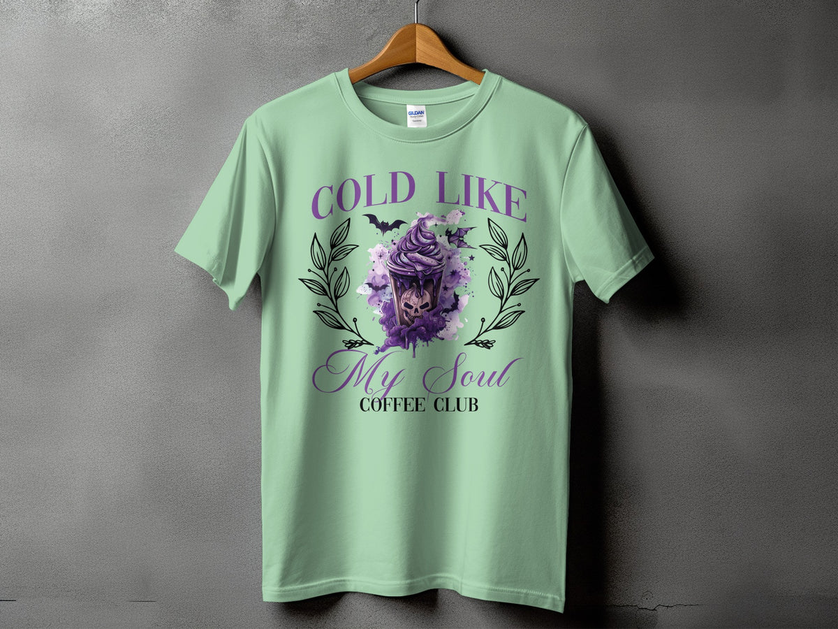 Mint t-shirt with purple "Cold Like My Soul Coffee Club" graphic featuring a skull drink.