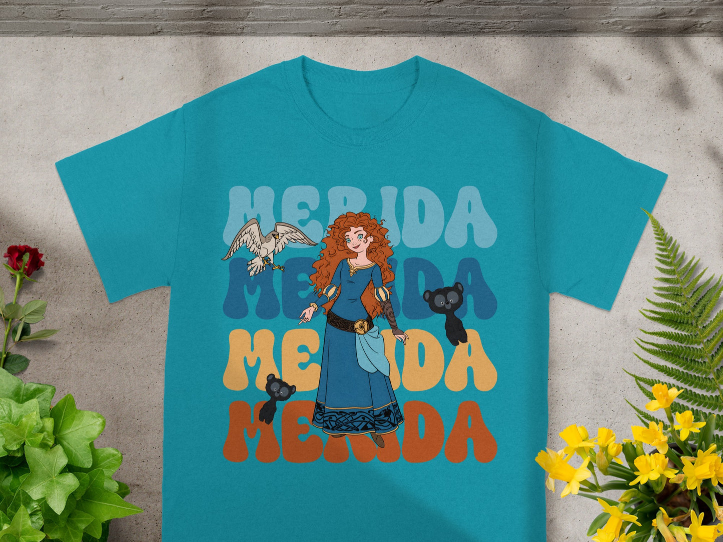 Merida from Brave with bear cubs and bird, on a teal t-shirt.