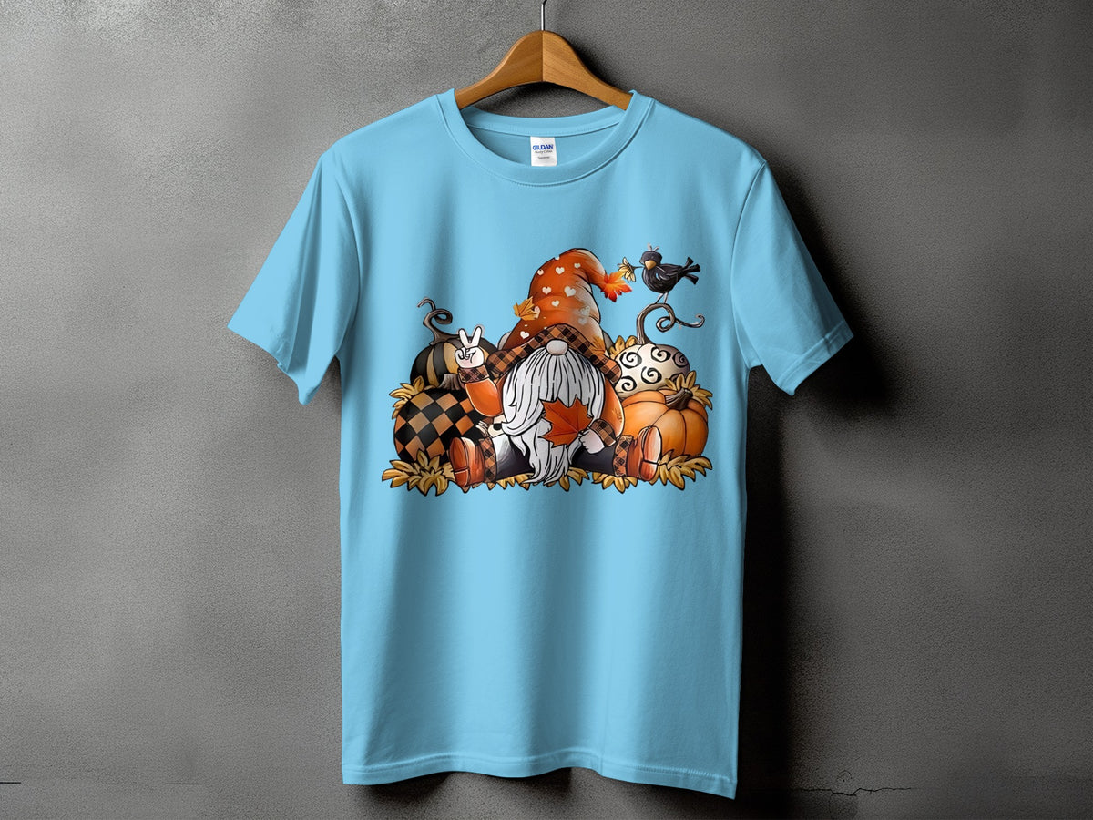 Light blue t-shirt with a fall gnome graphic surrounded by pumpkins and leaves.