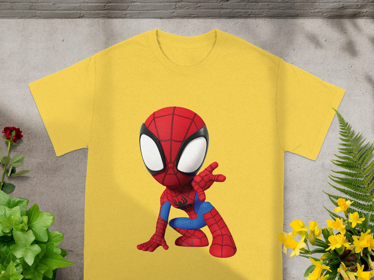 Yellow t-shirt with a cartoon Spiderman design in a crouched pose.