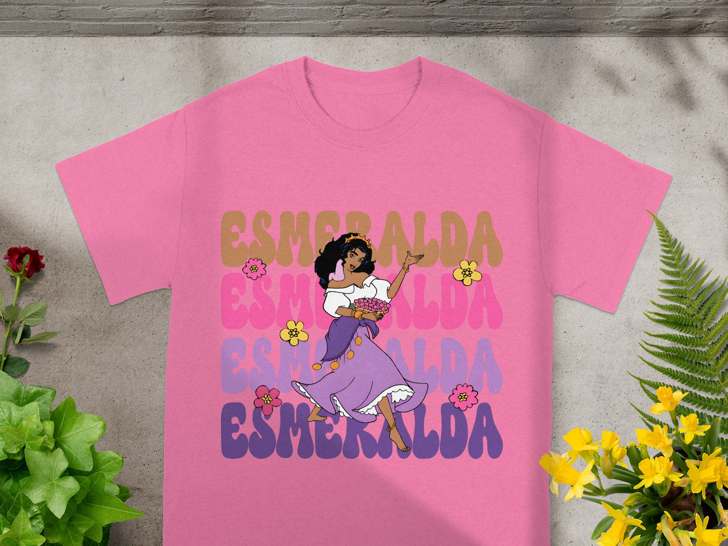 Pink t-shirt with Esmeralda graphic and floral accents.