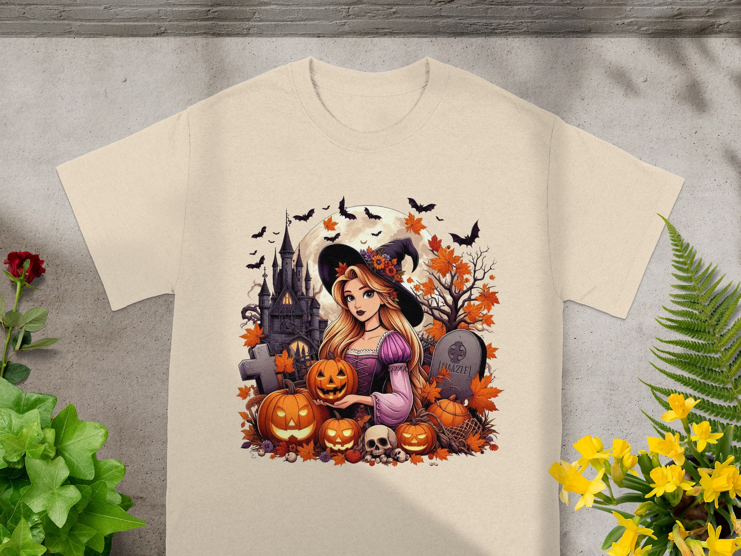 Cartoon witch with pumpkins and haunted castle Halloween design on a cream t-shirt.