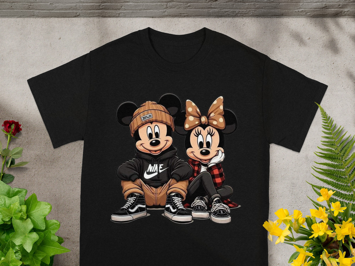 Mickey and Minnie Mouse characters wearing casual streetwear on a black t-shirt.