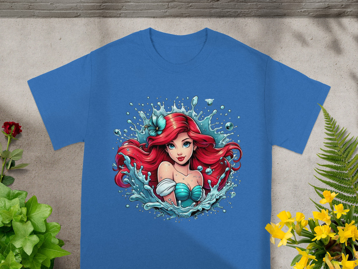Blue t-shirt with Ariel from The Little Mermaid splashing water.