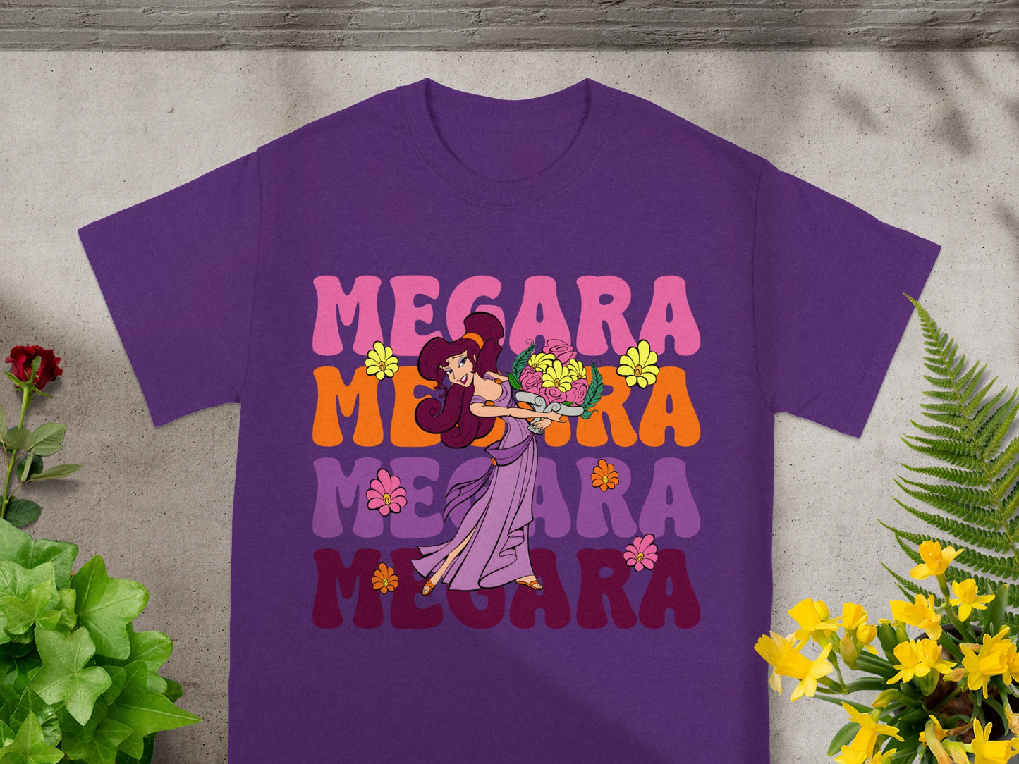 Purple t-shirt with Megara graphic and flowers in retro font.