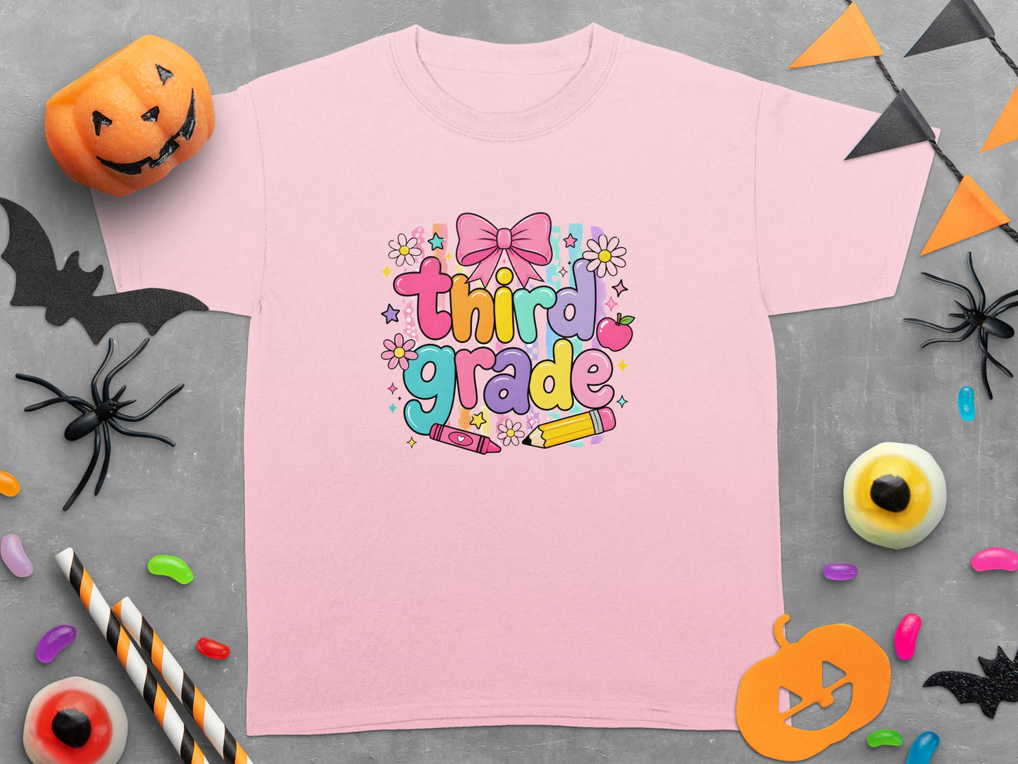 Pink t-shirt with "Third Grade" text and colorful decorations.