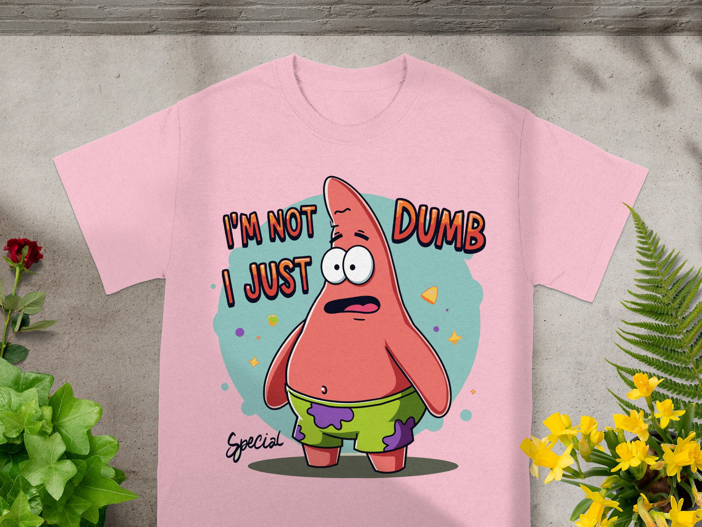 Pink t-shirt featuring Patrick Star from Spongebob saying "I'm not dumb, I just special."