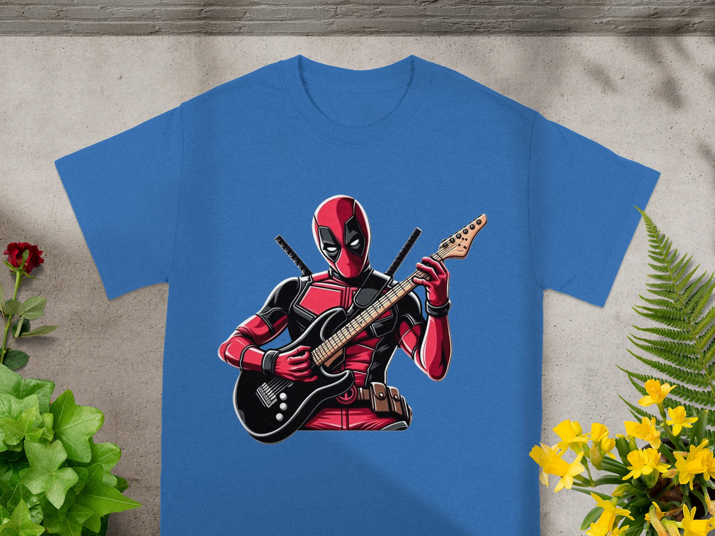 Blue t-shirt with Deadpool playing a red and black electric guitar.