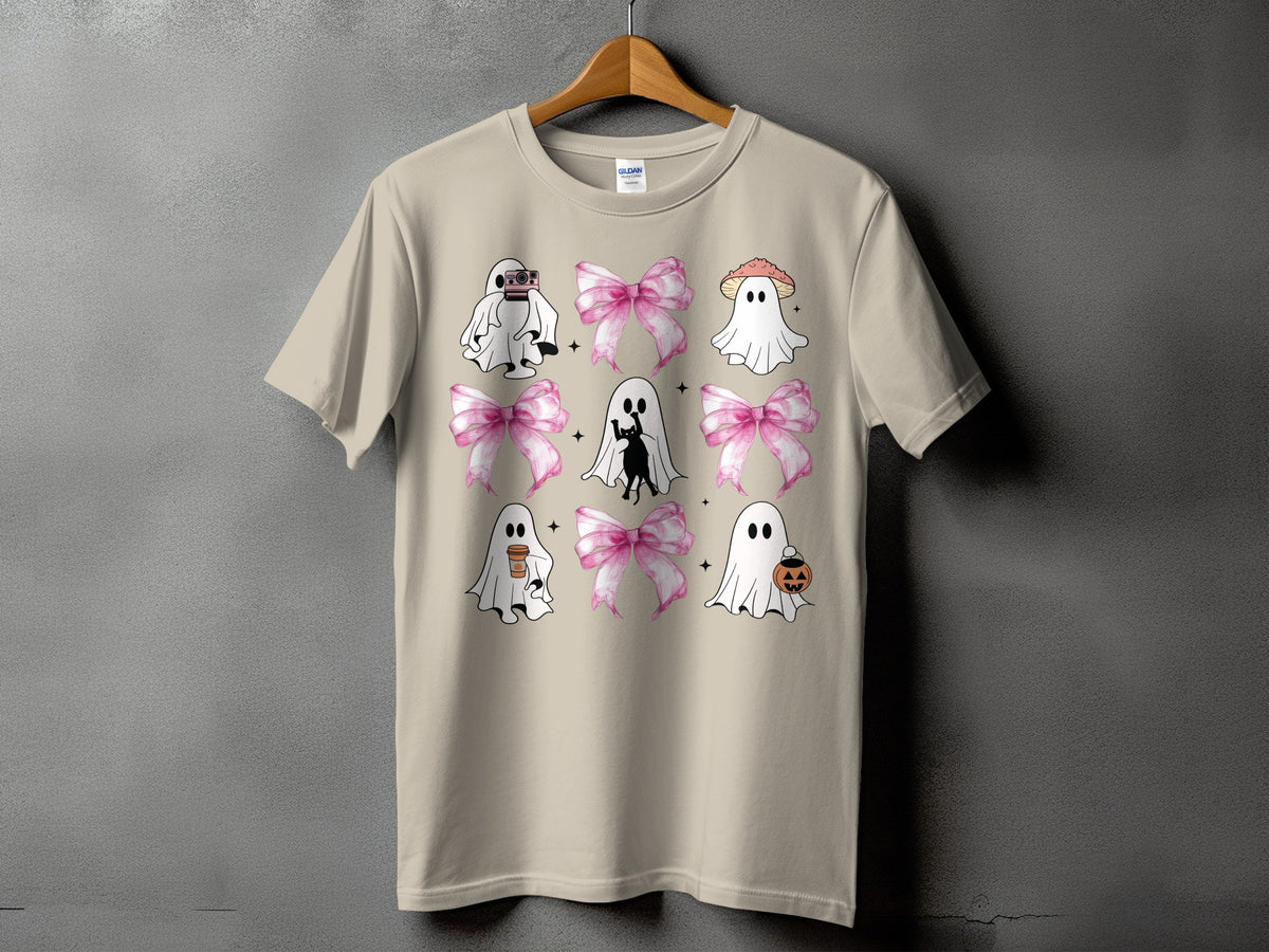 Tan t-shirt with a grid of cute ghosts, pink bows, and Halloween motifs.