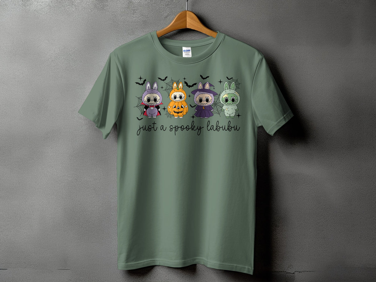 Green t-shirt with four spooky Labubu characters and text "just a spooky labubu".