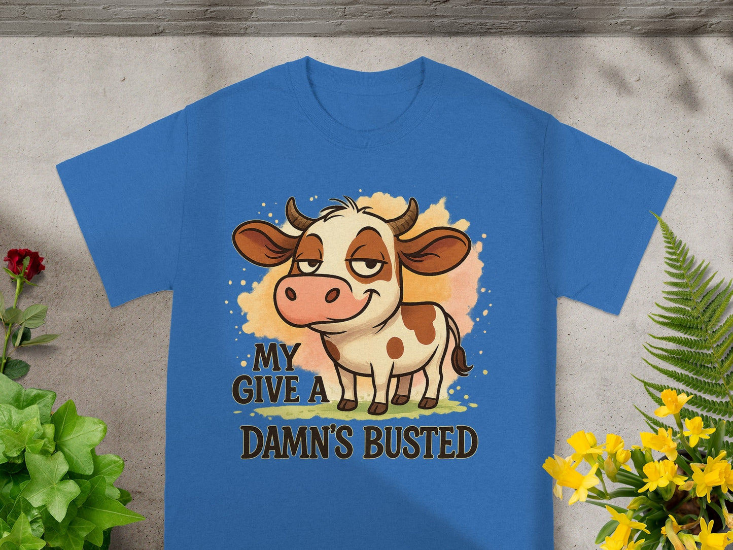 Blue t-shirt with cartoon cow and text "MY DAMN'S BUSTED".