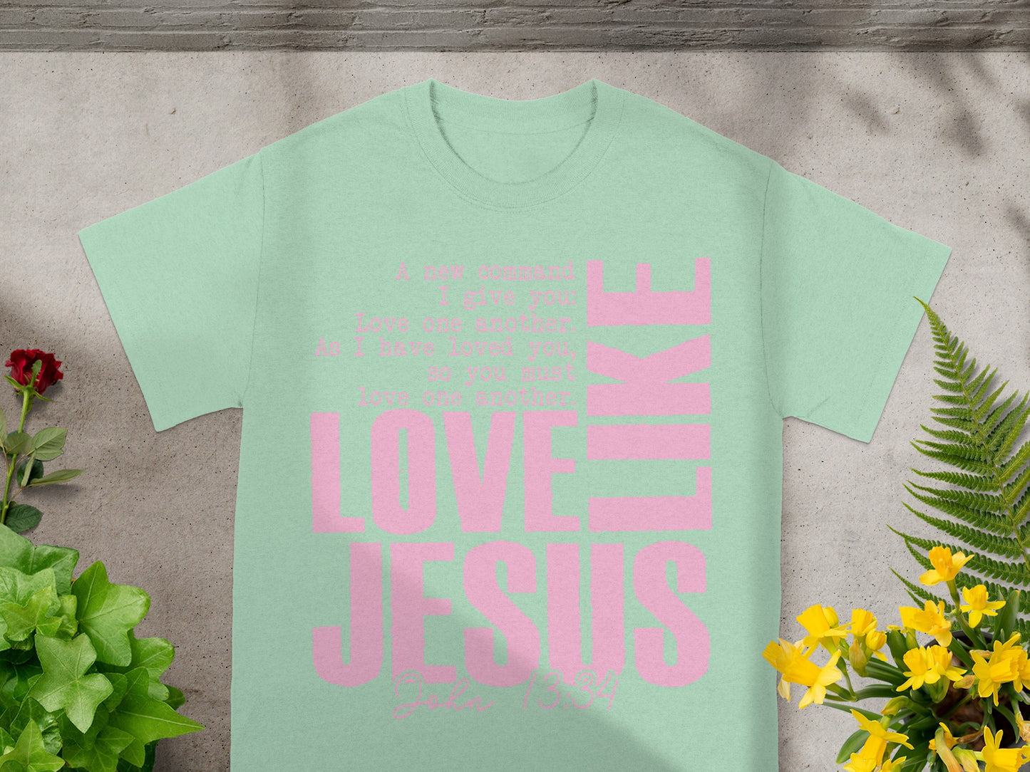 Mint green t-shirt with pink text: "LOVE JESUS", John 13:34.
