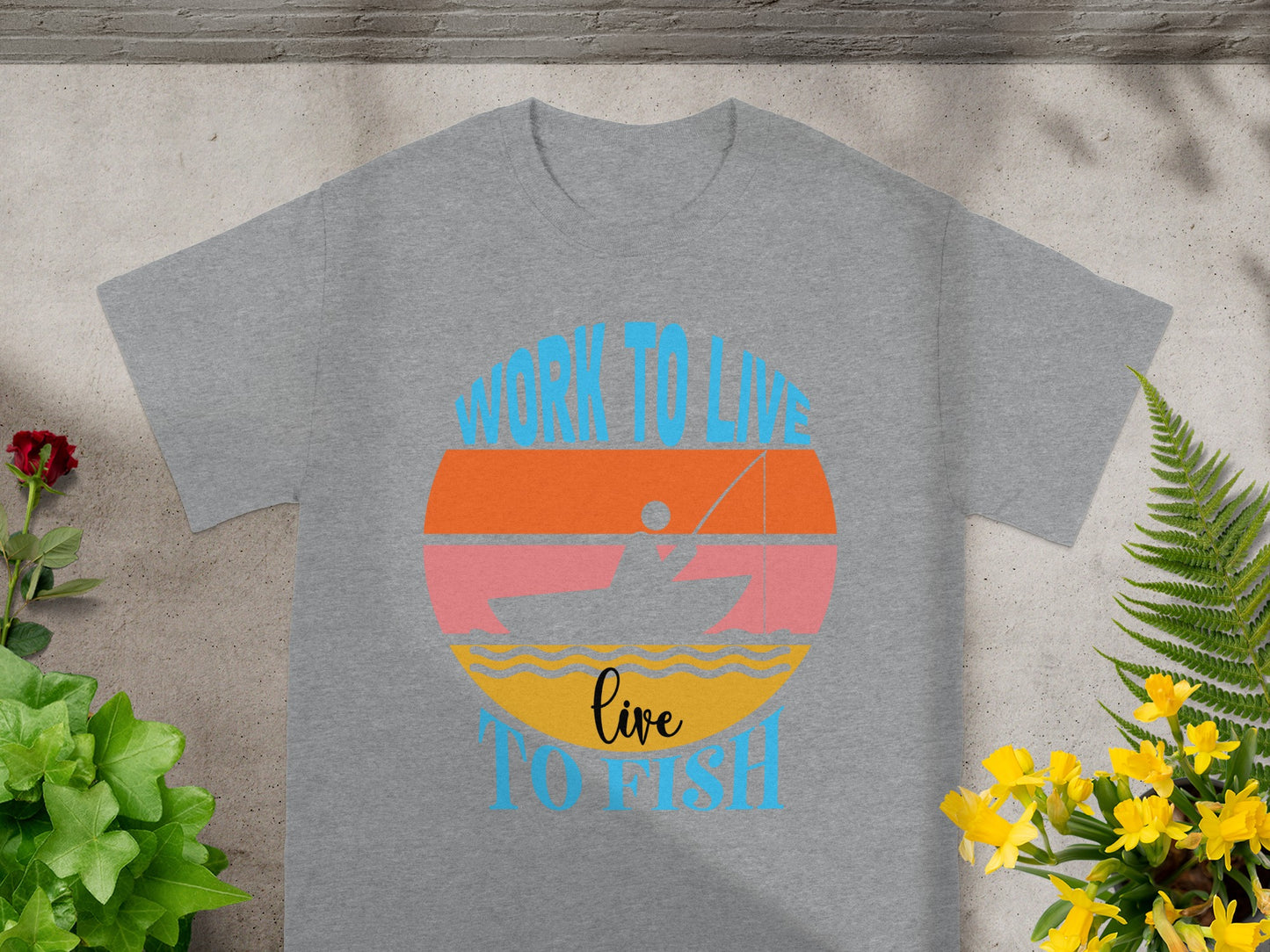 Grey t-shirt with graphic "WORK TO LIVE live TO FISH" and a fishing boat sunset.