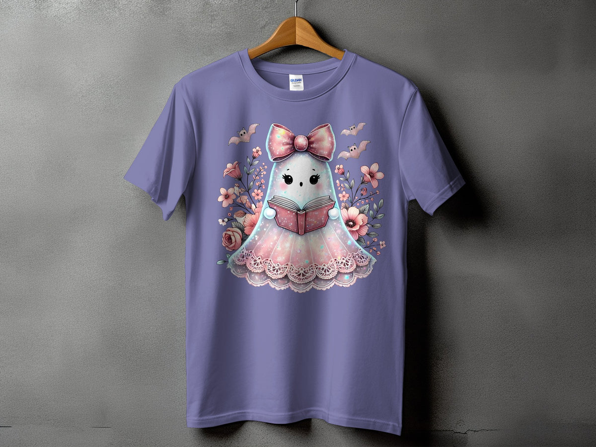 Purple t-shirt with a cute ghost reading a book surrounded by flowers and bats.