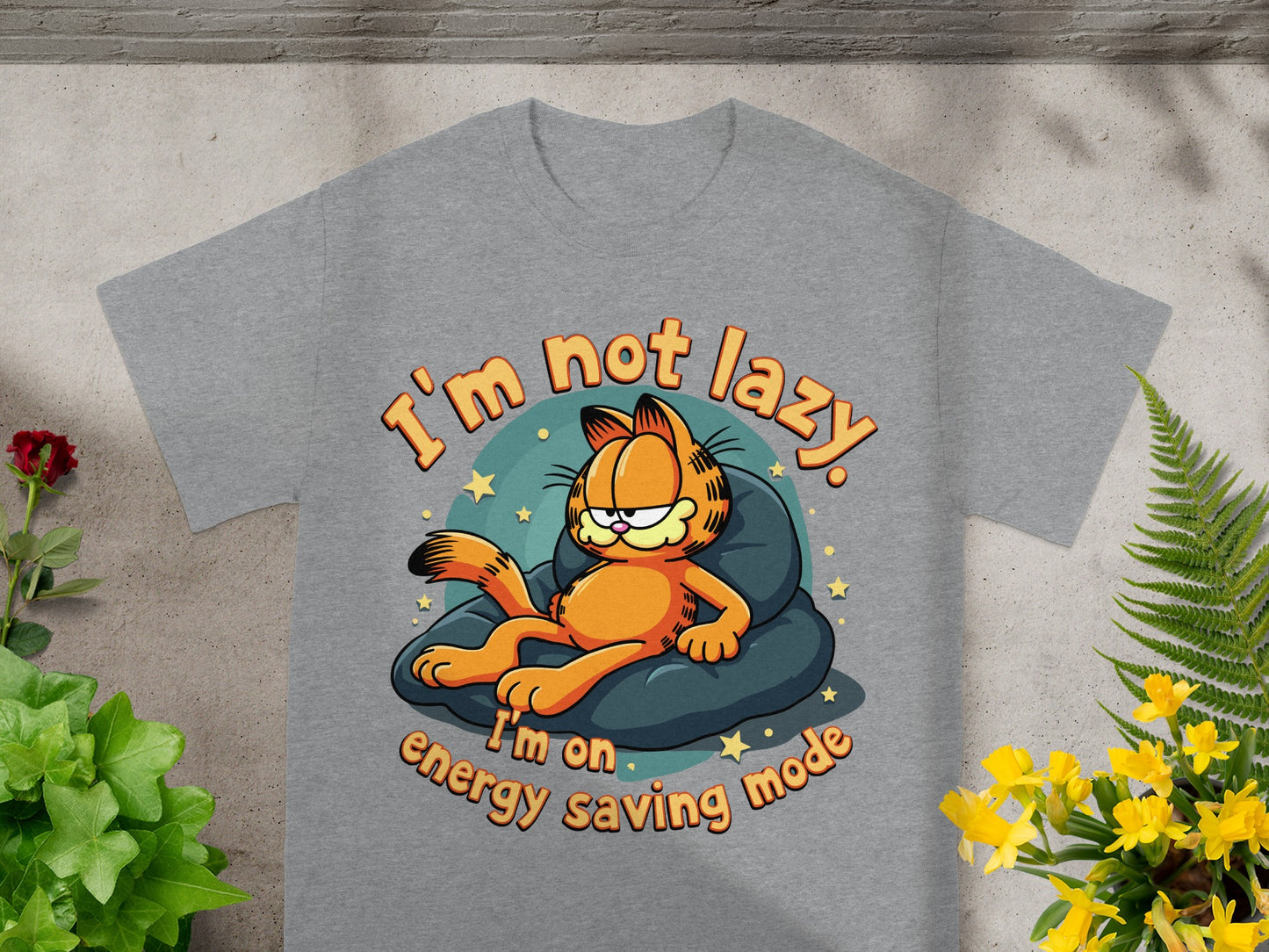 Garfield lying on a pillow with text "I'm not lazy. I'm on energy saving mode."