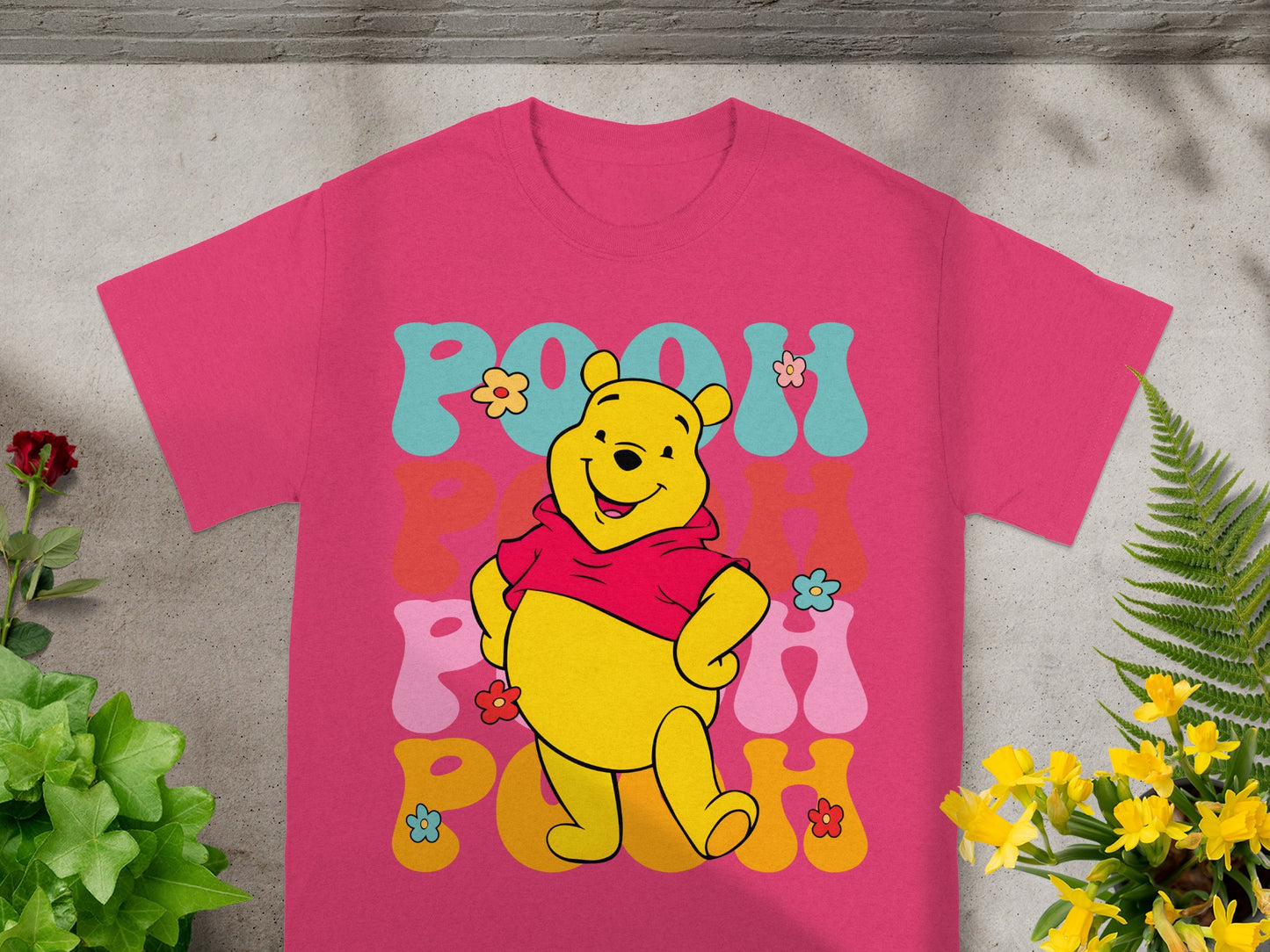 Winnie the Pooh graphic t-shirt with colorful "Pooh" text.