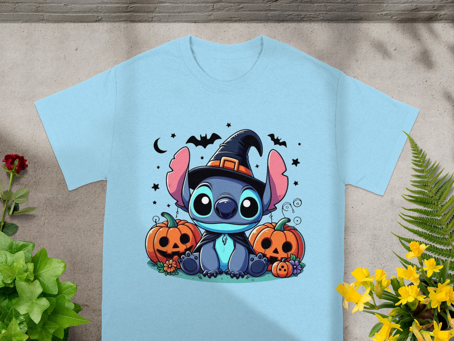 Light blue t-shirt with Stitch wearing a witch hat surrounded by pumpkins and bats.