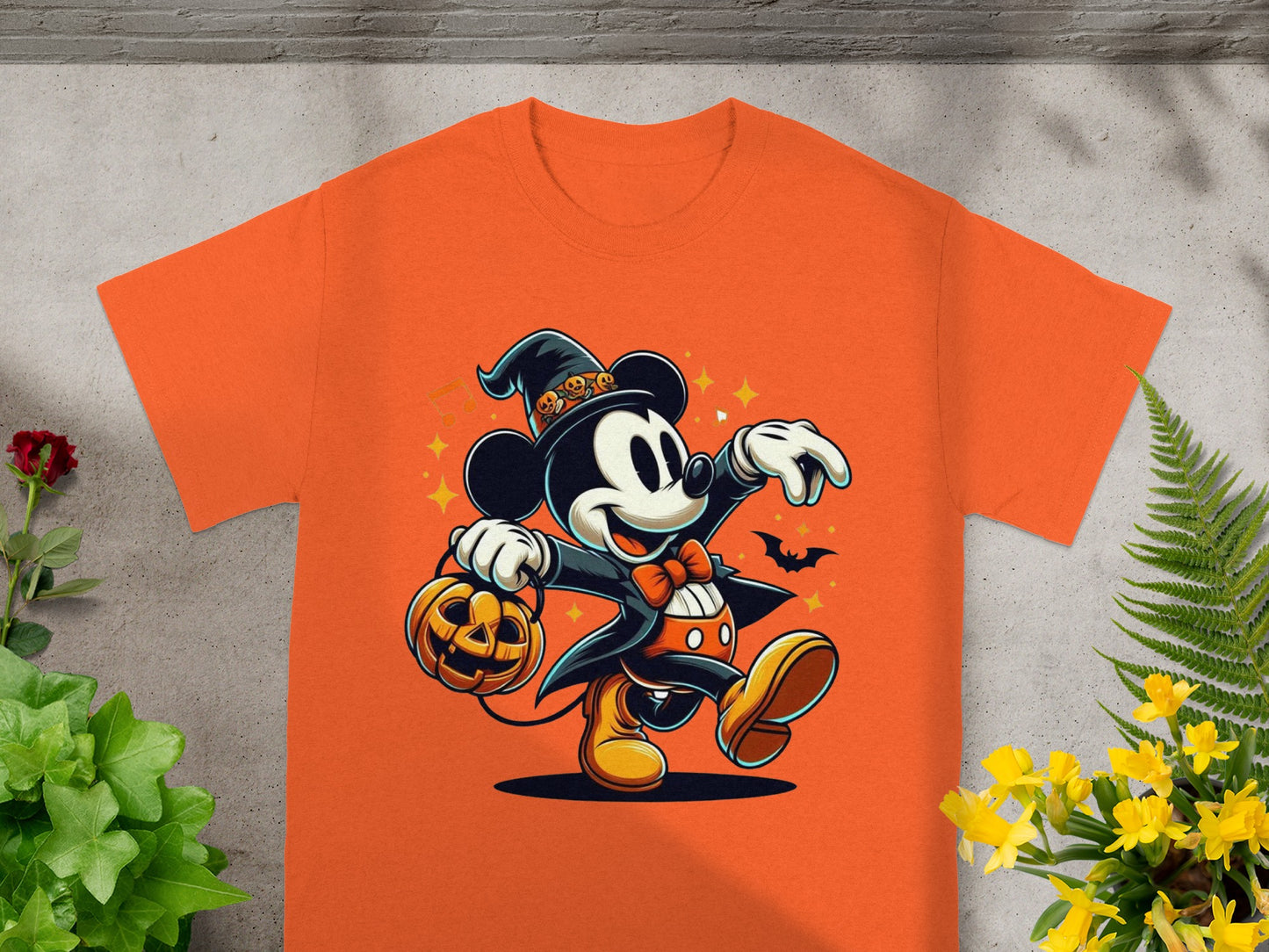 Orange t-shirt with Halloween Mickey Mouse graphic holding a pumpkin bucket.