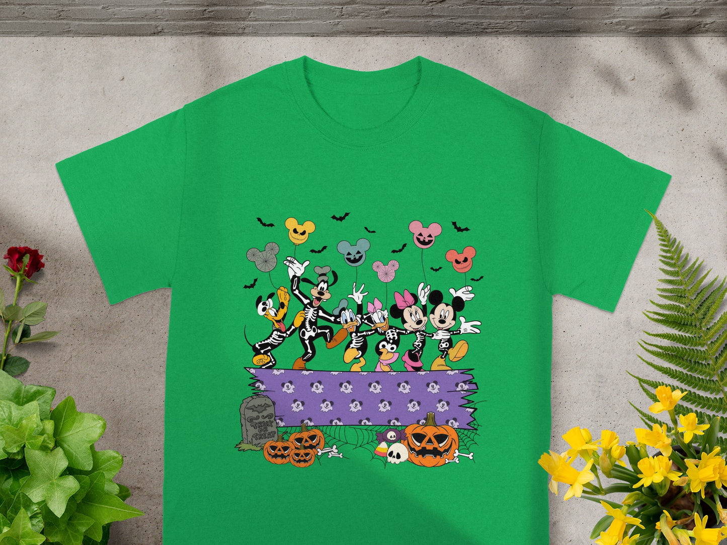 Mickey and friends in skeleton costumes with Halloween decorations and balloons.