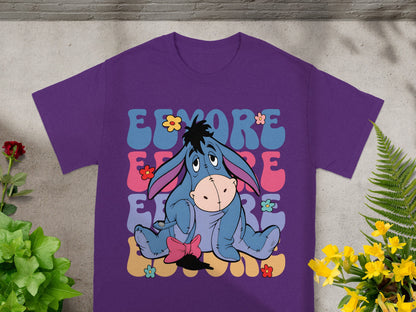 Purple t-shirt with Eeyore sitting among colorful flowers and text.
