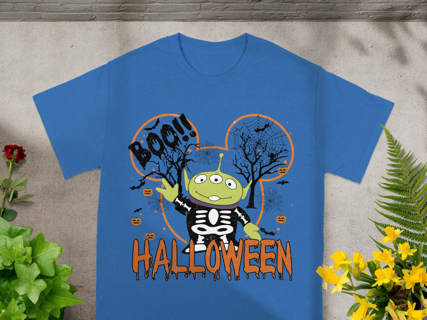 Alien toy in skeleton costume with "BOO!!" and "Halloween" text.