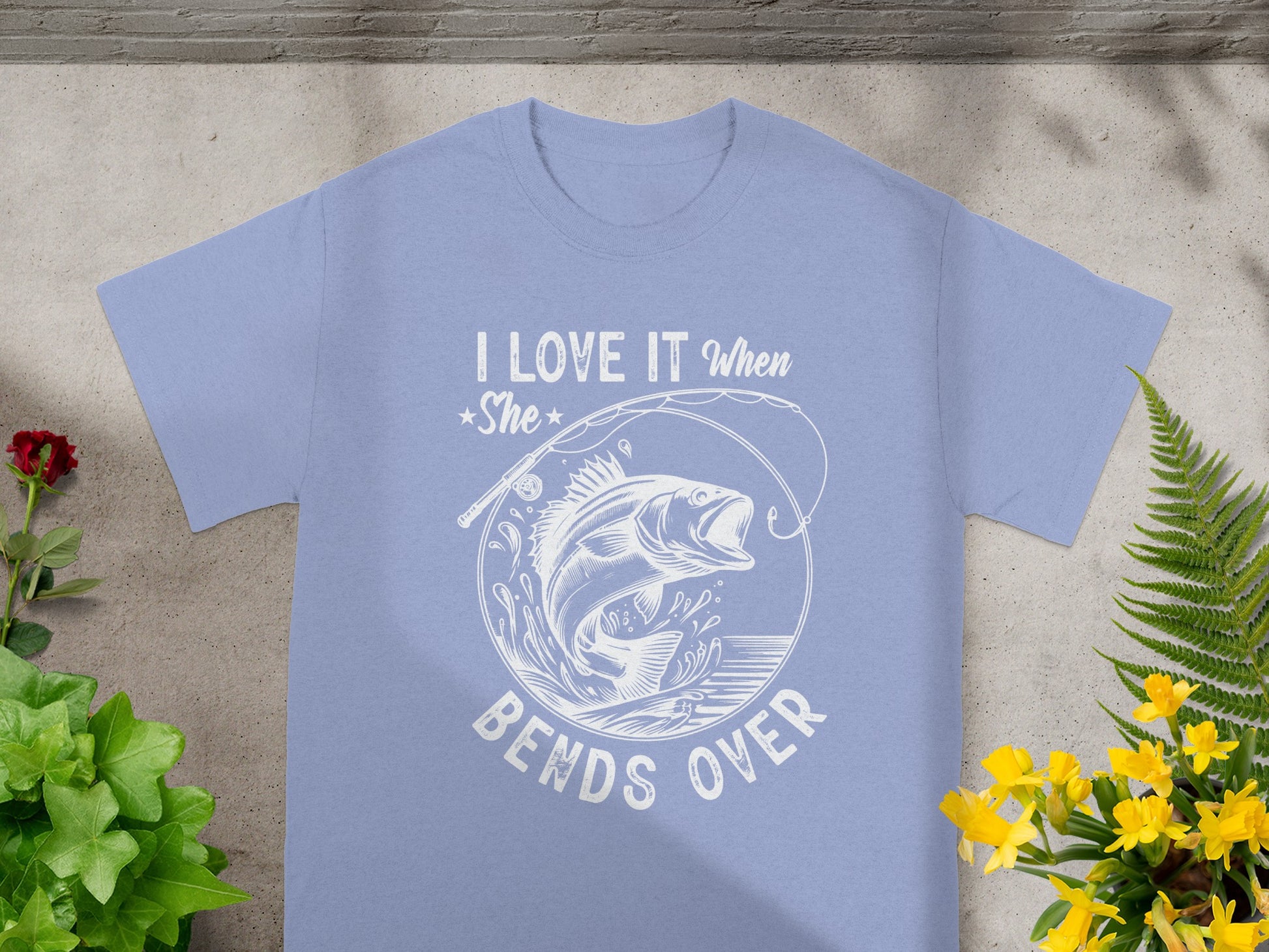 Light blue t-shirt with white graphic: "I LOVE IT WHEN She BENDS OVER" and a fish.