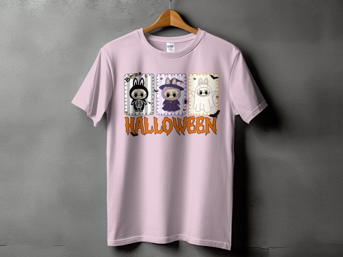 Pink t-shirt with Halloween graphic featuring three cartoon characters and text.