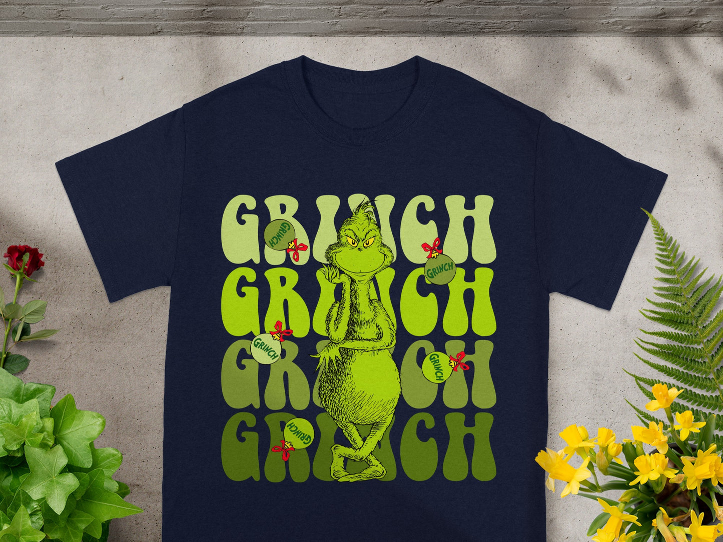 Navy t-shirt with "Grinch" in large green lettering and a Grinch graphic.