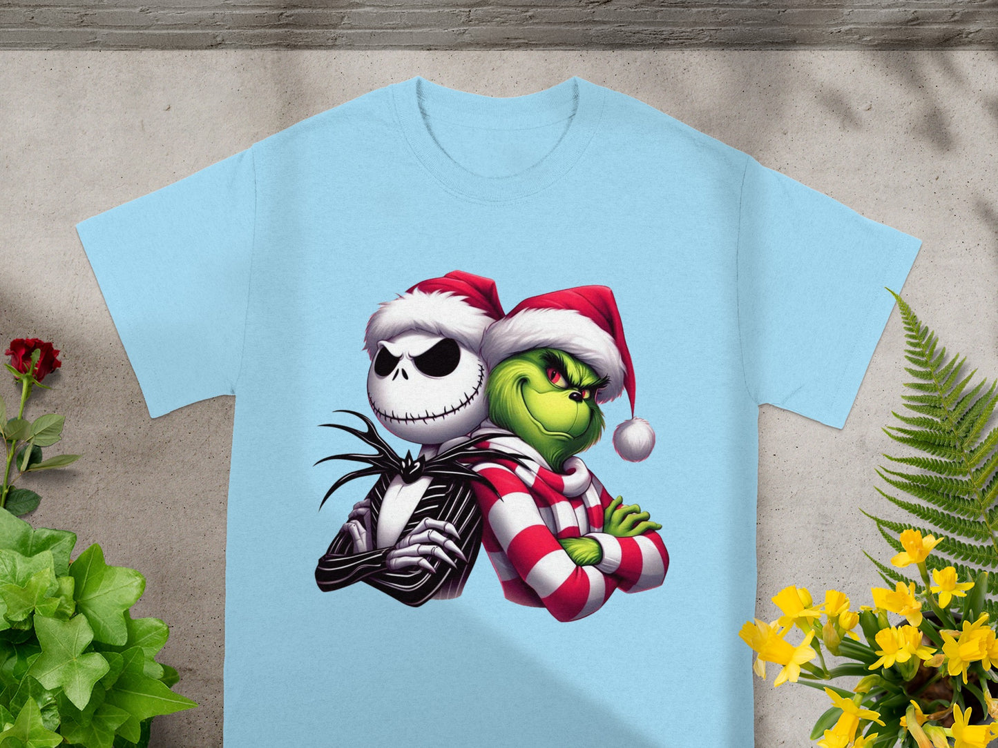 Jack Skellington and The Grinch wearing Santa hats on a light blue t-shirt.