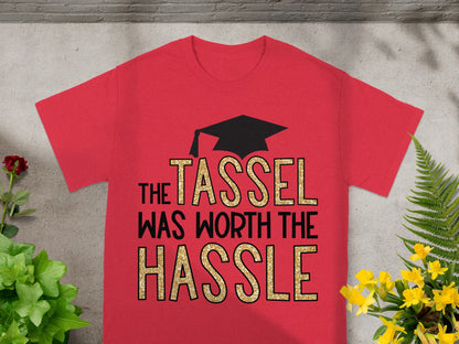 Red t-shirt with black graduation cap and gold glitter text "The Tassel Was Worth the Hassle."