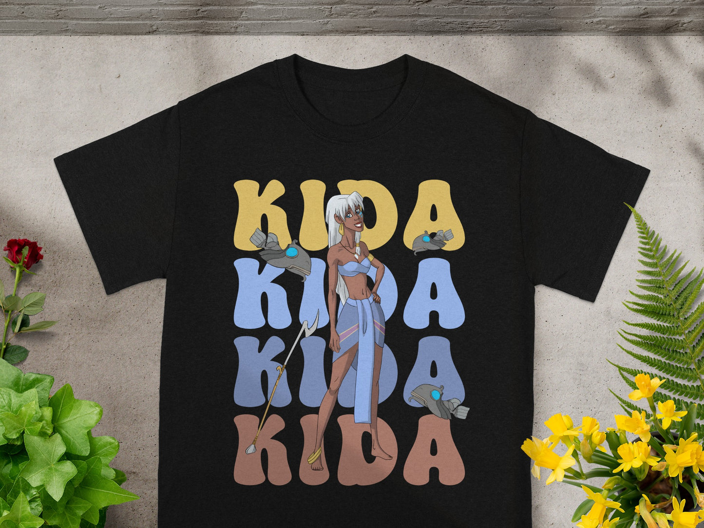 Black t-shirt with Kida's name repeated in stylized lettering.