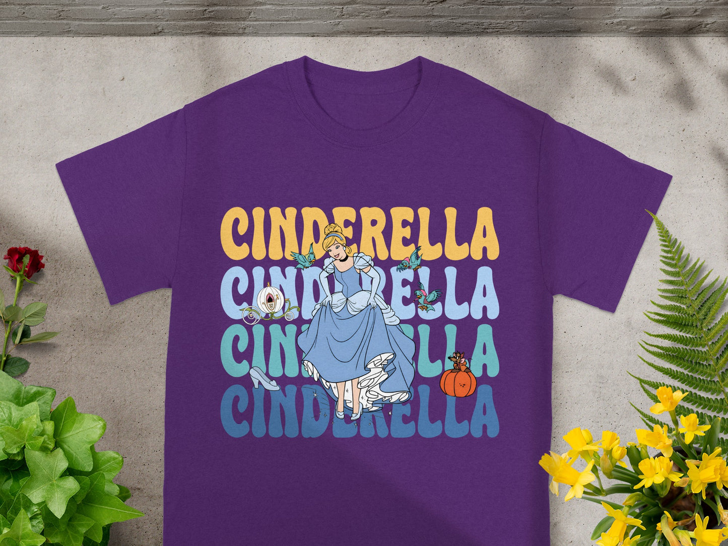 Purple t-shirt with Cinderella graphic and text, featuring the character and pumpkin.