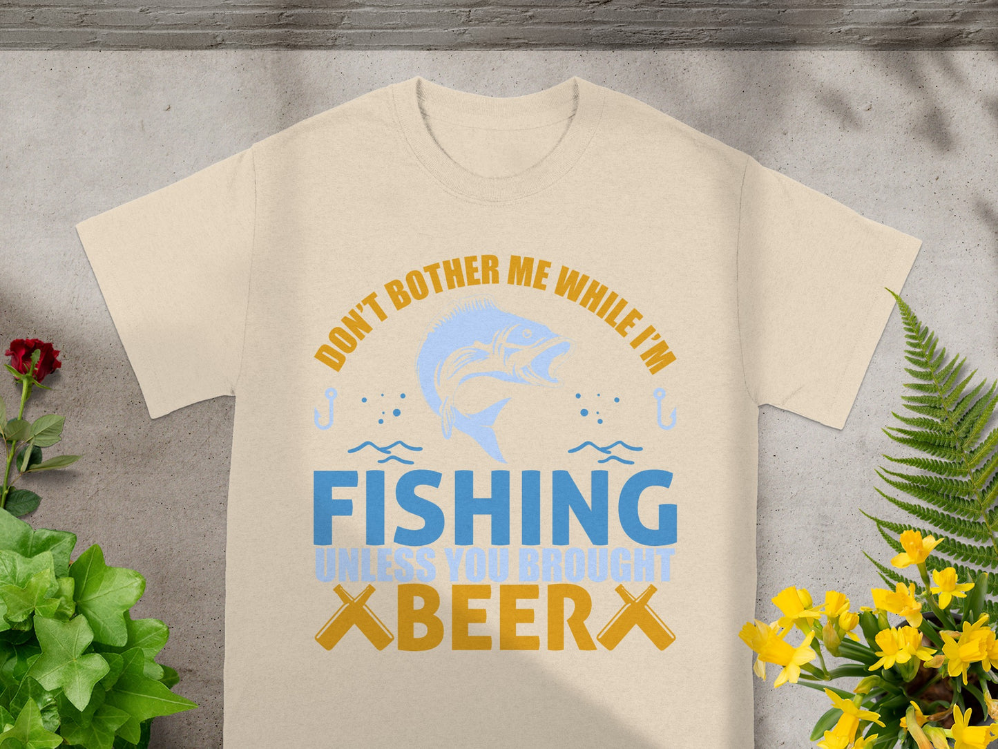 Cream t-shirt with a distressed graphic saying "Don't Bother Me While I'm Fishing Unless You Brought Beer".