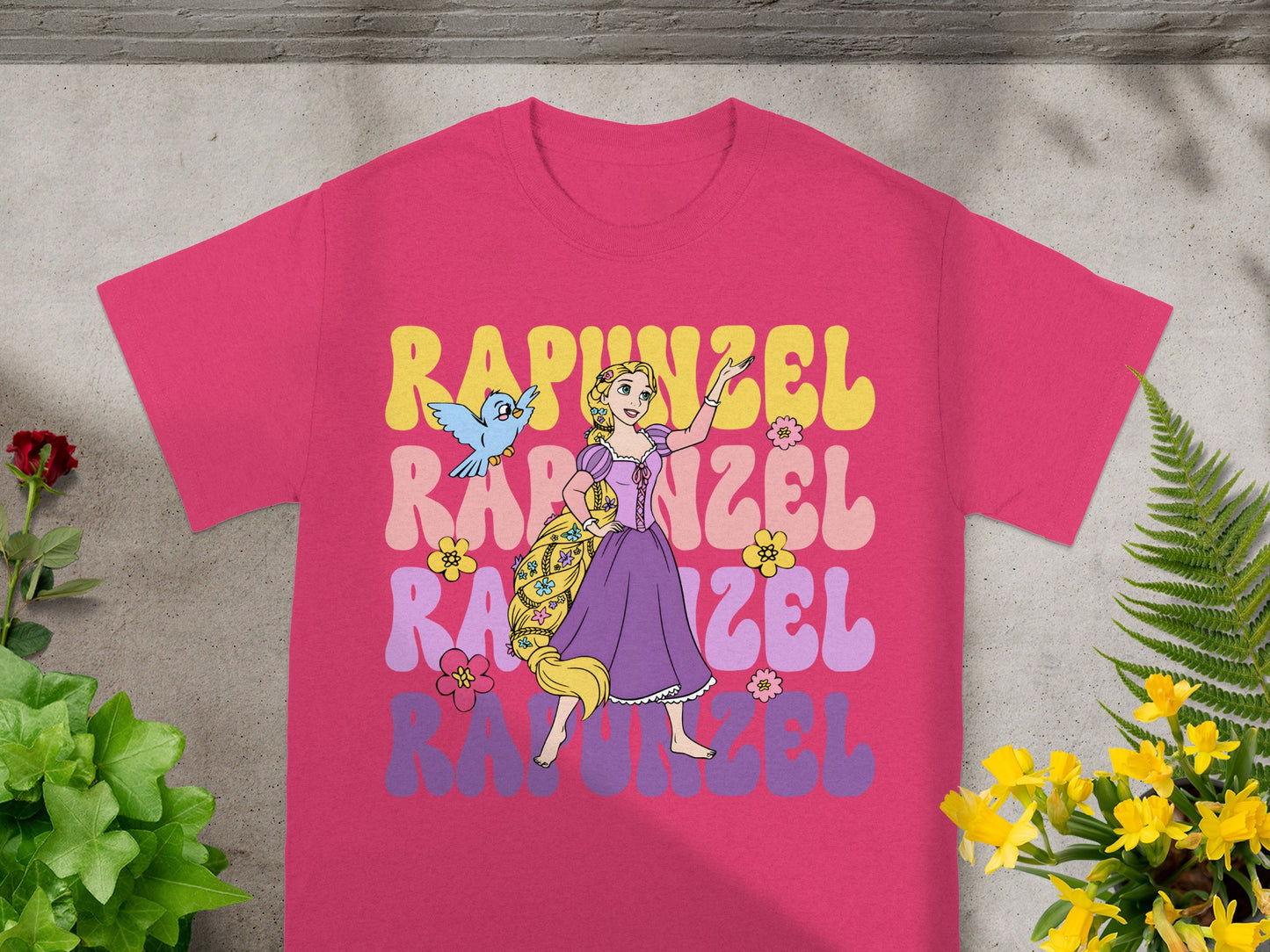 Rapunzel in wavy pastel letters with Pascal on a pink t-shirt.
