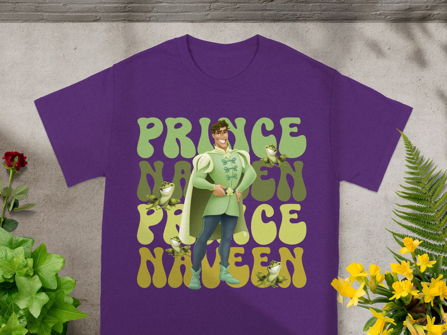 Purple t-shirt with Prince Naveen graphic and frog accents.