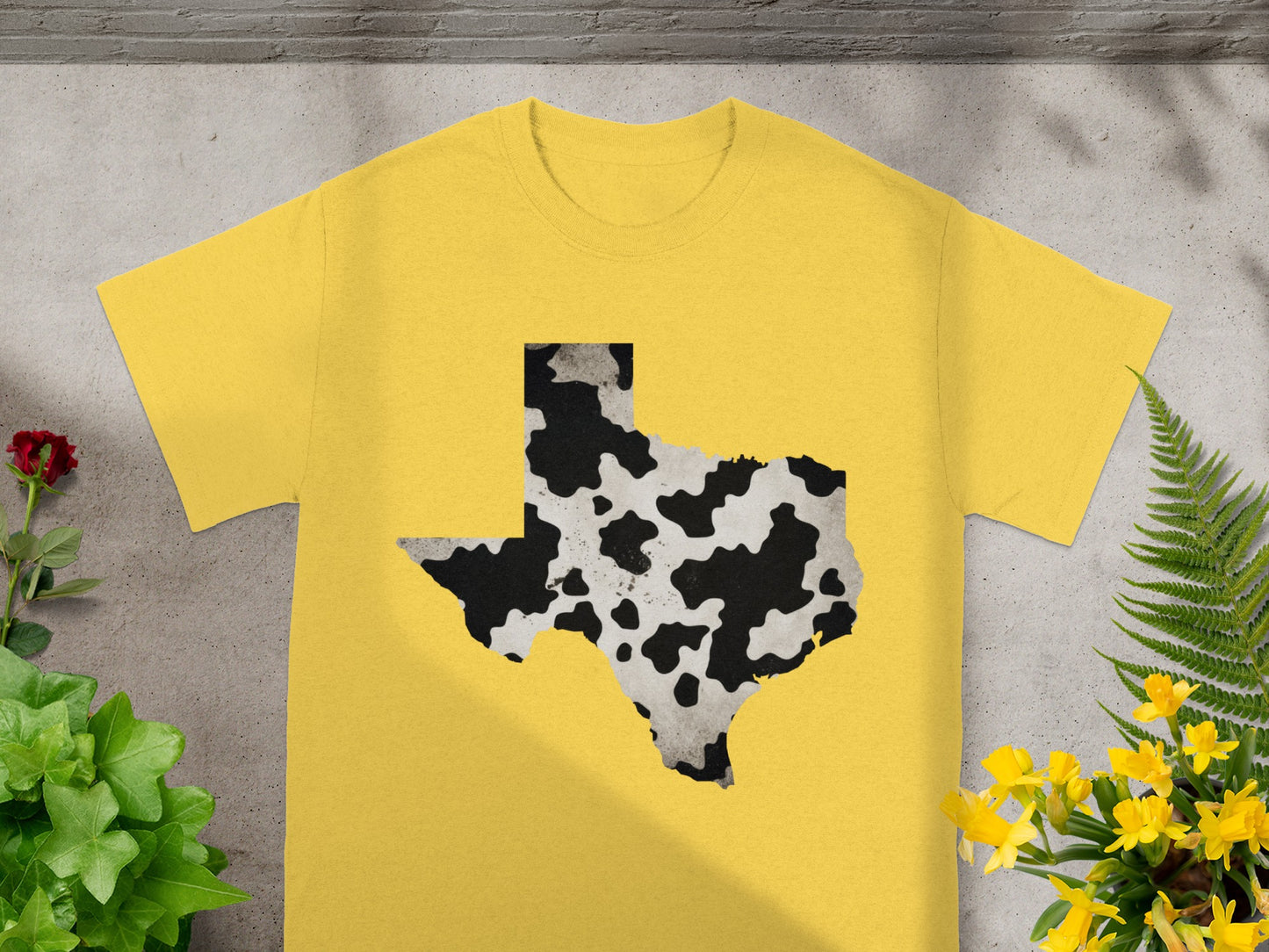 Yellow t-shirt with Texas shape featuring cow print design.