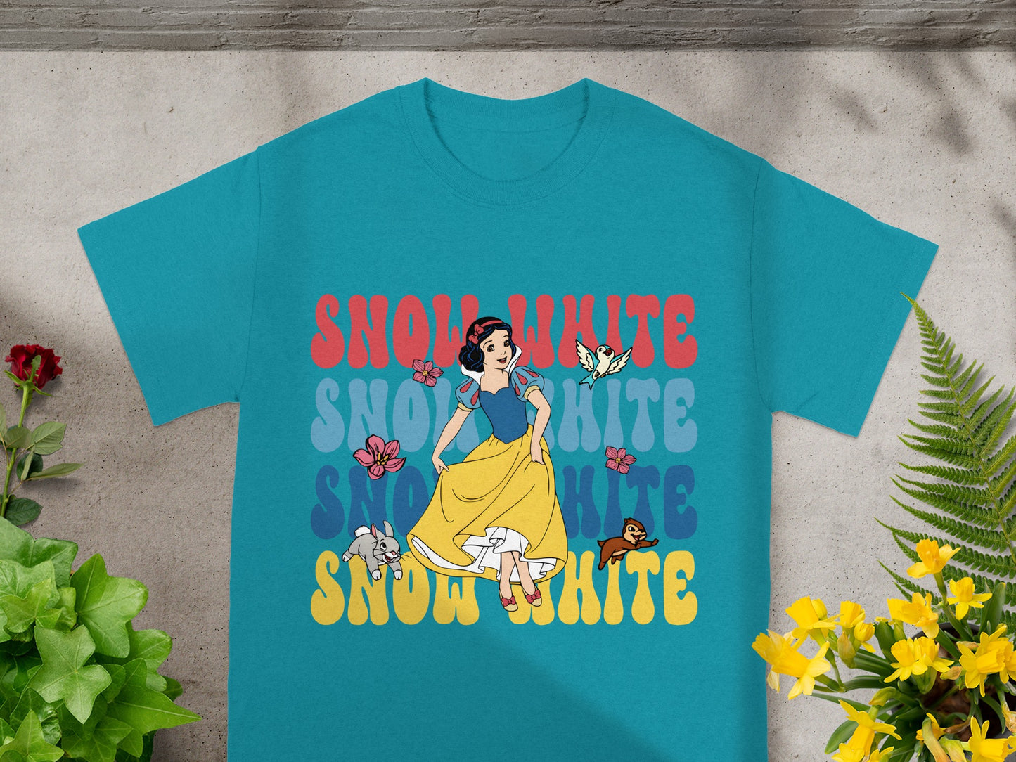 Teal t-shirt with "Snow White" text in red, white, and yellow, featuring Snow White character.