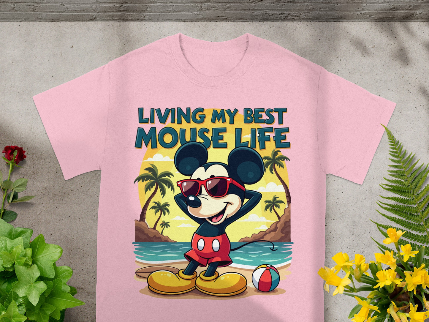 Pink t-shirt with Mickey Mouse on a beach, reading "Living My Best Mouse Life."
