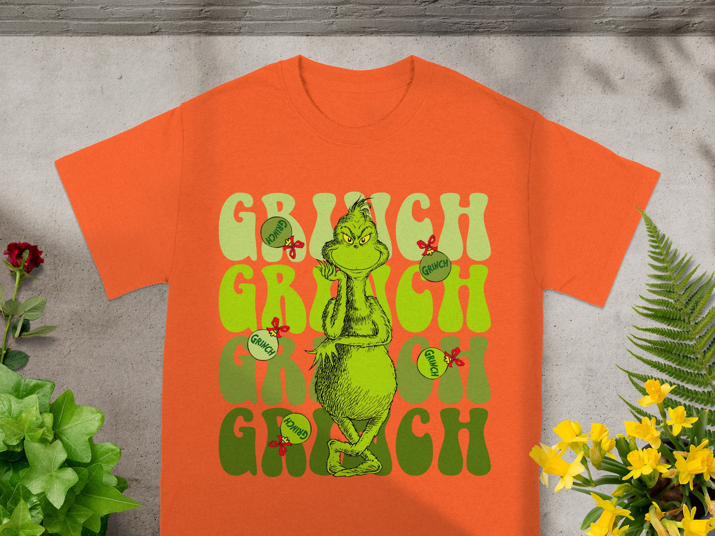 Orange t-shirt with "Grinch" text and the character.