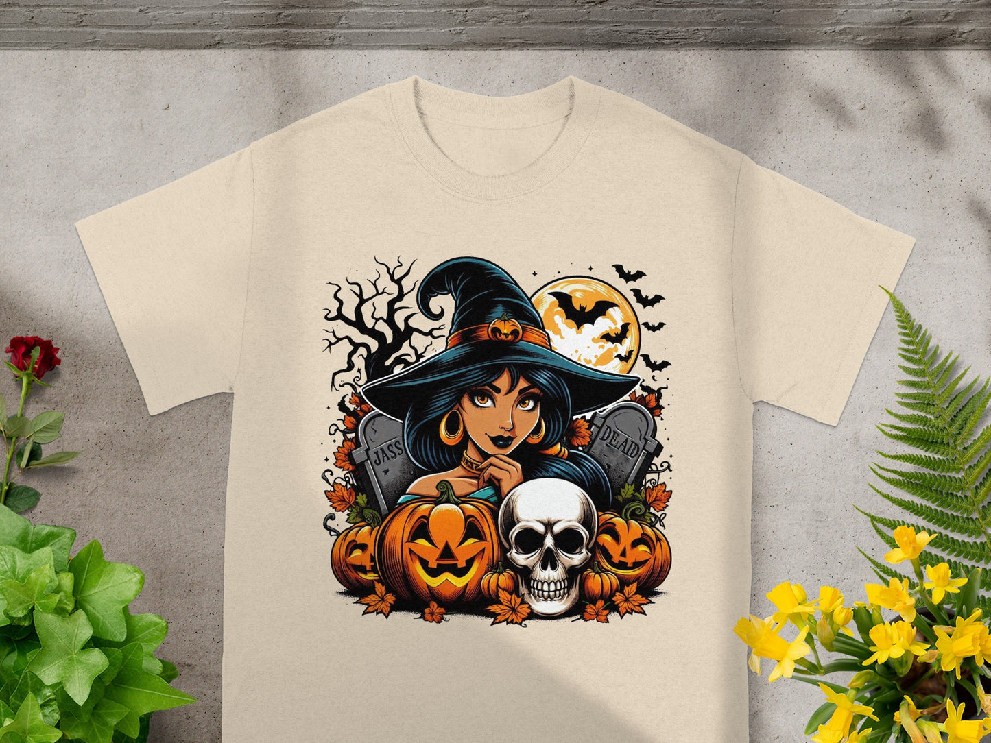 Halloween t-shirt graphic with witch, pumpkins, skull, and tombstones.