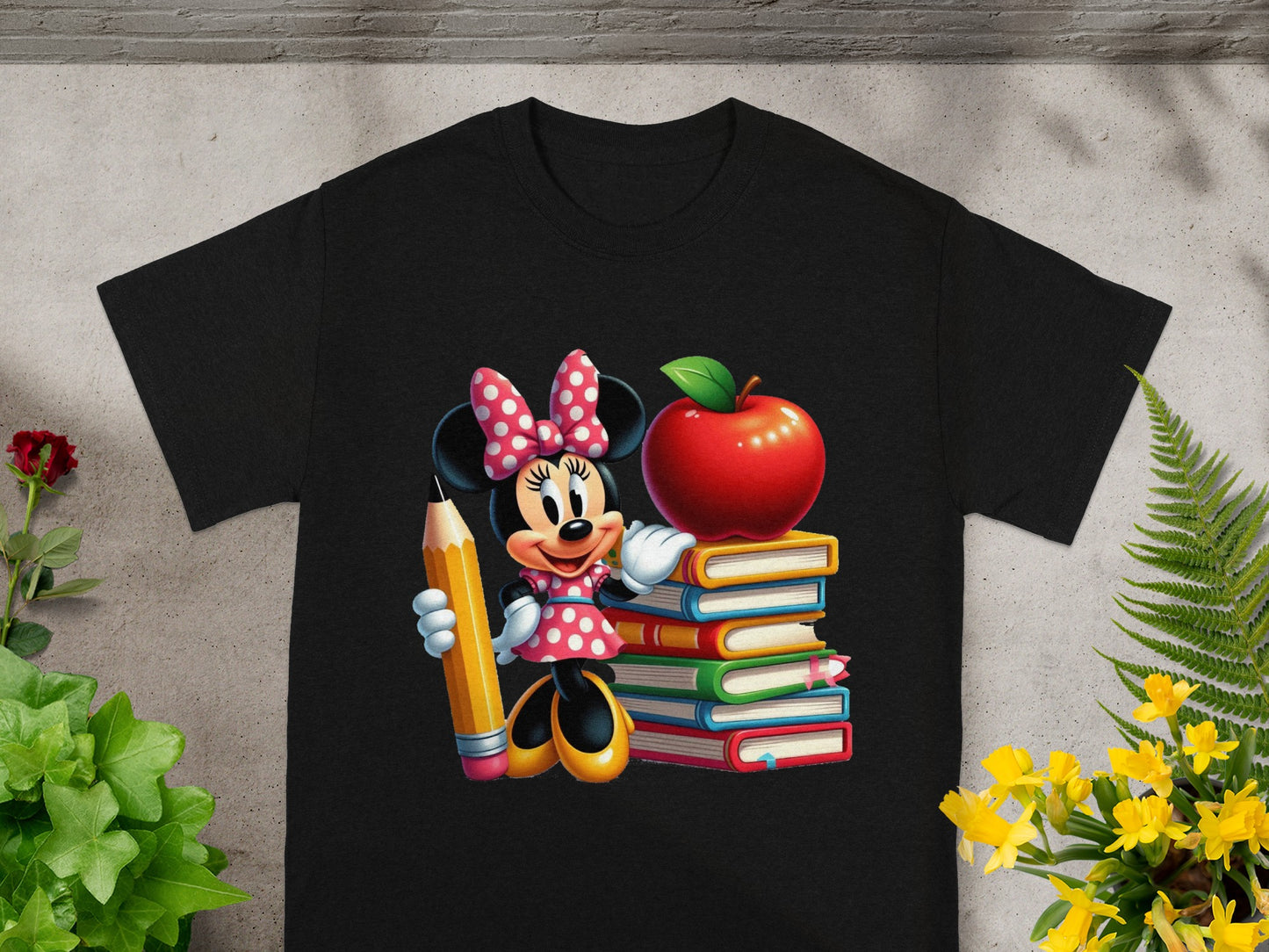 Minnie Mouse holding a pencil, standing by stack of books and an apple.