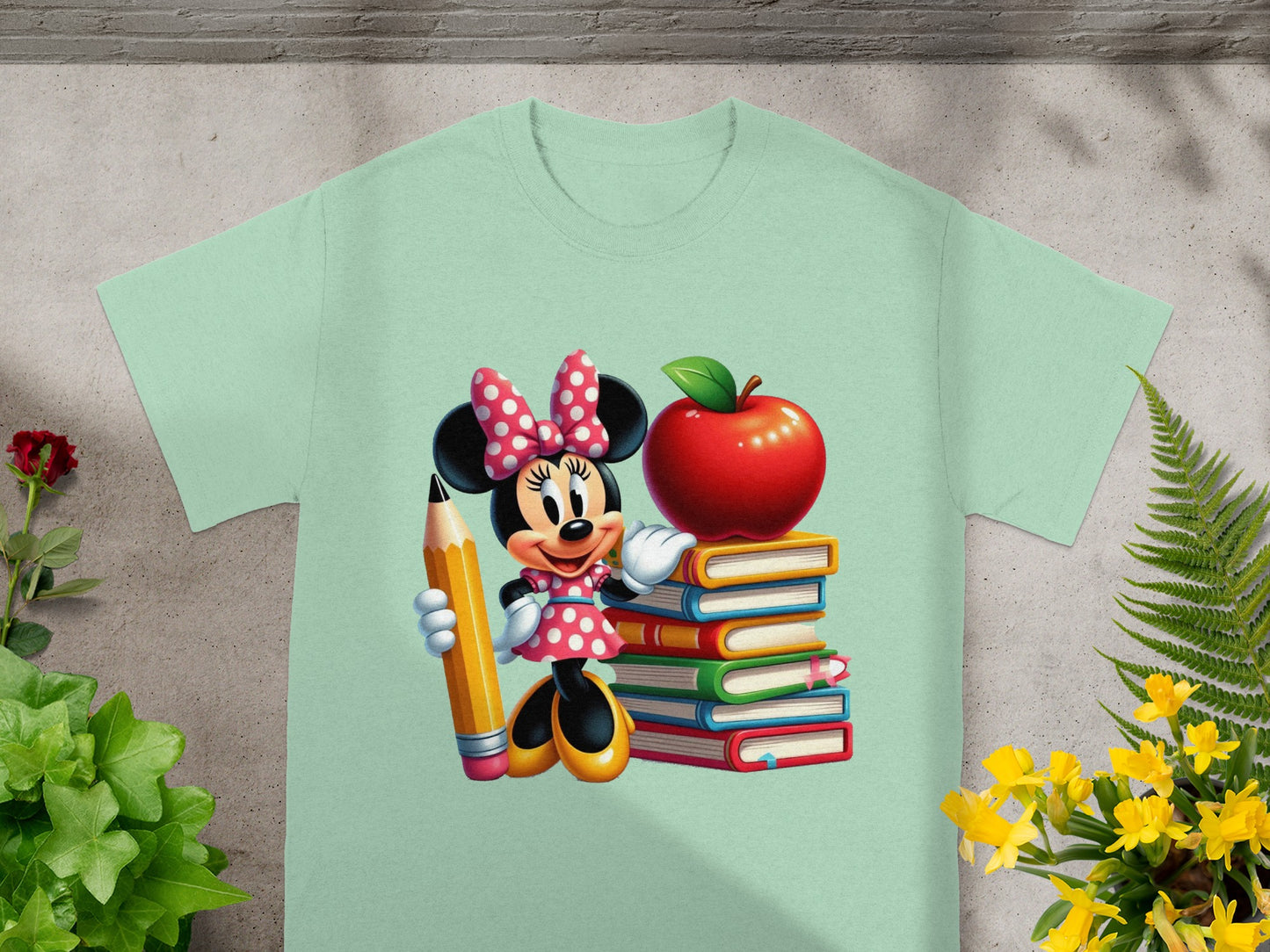 Minnie Mouse holding a pencil next to a stack of books and an apple.