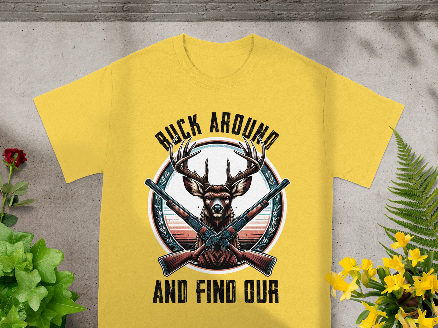 Yellow t-shirt with deer, crossed rifles, and text "BUCK AROUND AND FIND OUR."