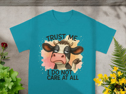 Teal t-shirt with a cartoon cow saying "Trust me I do not care at all".