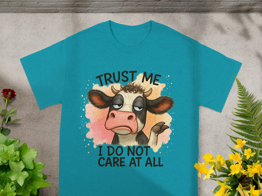 Teal t-shirt with a cartoon cow saying "Trust me I do not care at all".